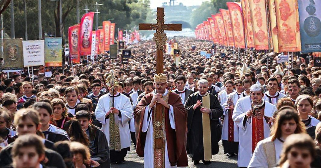A procession during the Australian Catholic Youth Festival with the World Youth Day Cross and Icon, led by an antipope and clergy in modernist attire.