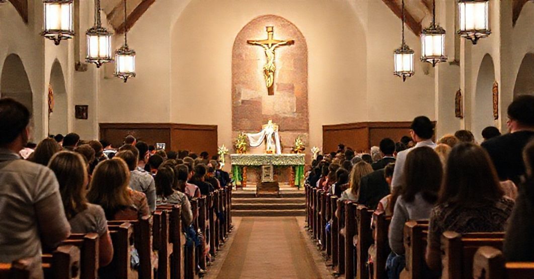 A historic Catholic chapel at a university Newman Center with young students attending Mass, highlighting the contrast between outward beauty and doctrinal corruption in conciliar campus ministries.