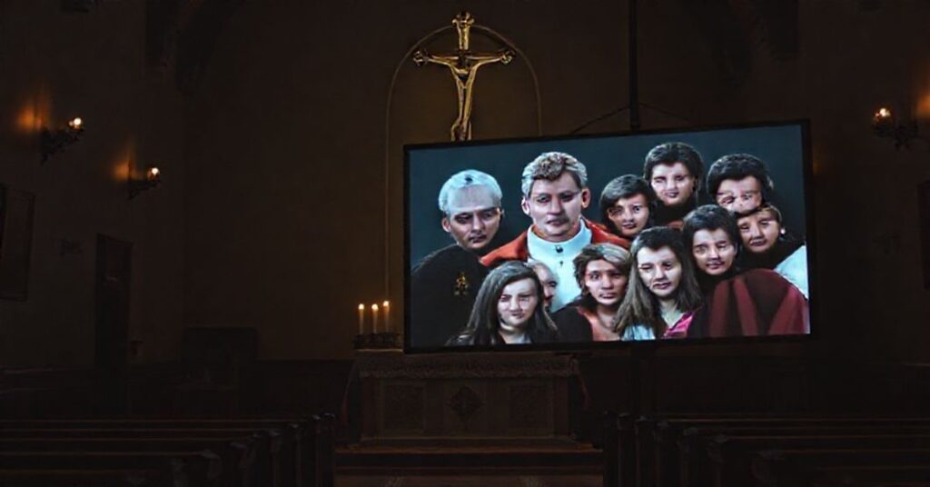 A dimly lit chapel with a traditional Catholic altar contrasted by a digital screen displaying antipope Leo XIV in a staged dialogue with youth.